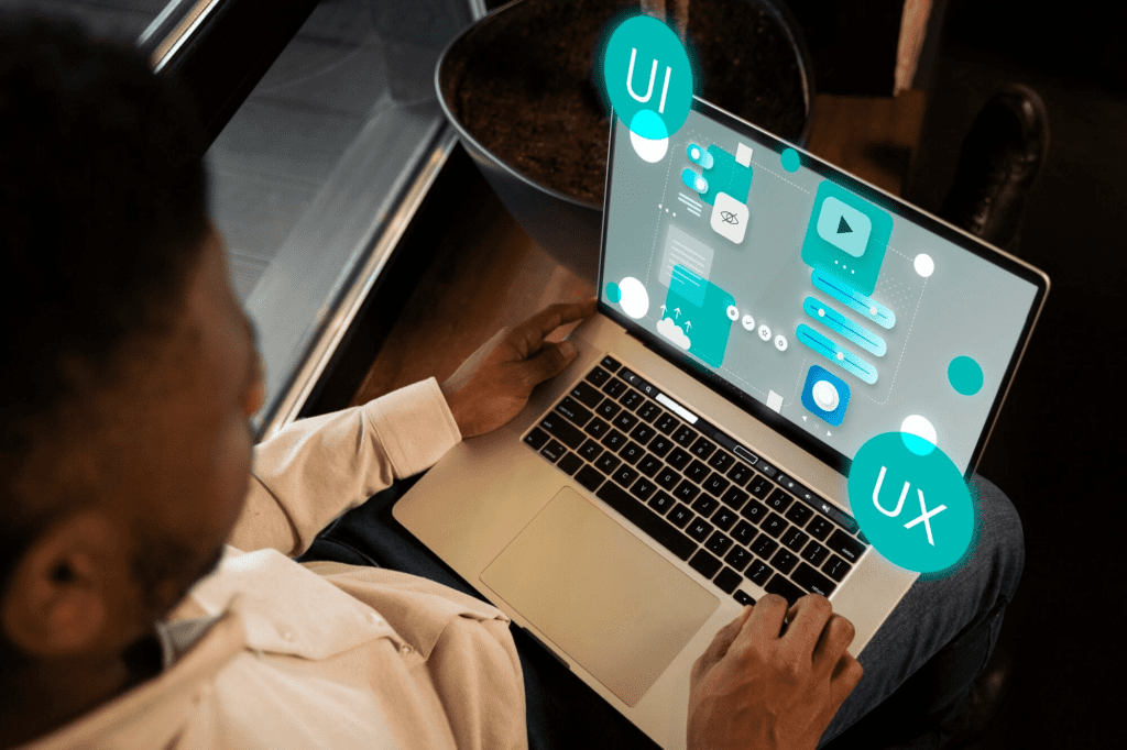 Do WordPress Plugins Slow Down Website? 3 A man working on a laptop that showcases UI icons, while exploring the impact of WordPress plugins on website speed.
