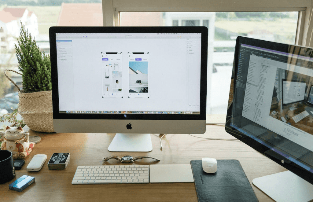What is the Most Useful WordPress Theme? 2 A desk with two monitors and a computer set up for work.