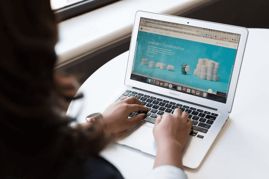 Check Out the WordPress Latest Version 2023 With New Features 4 A woman is using a laptop to access a website on the latest version of WordPress.