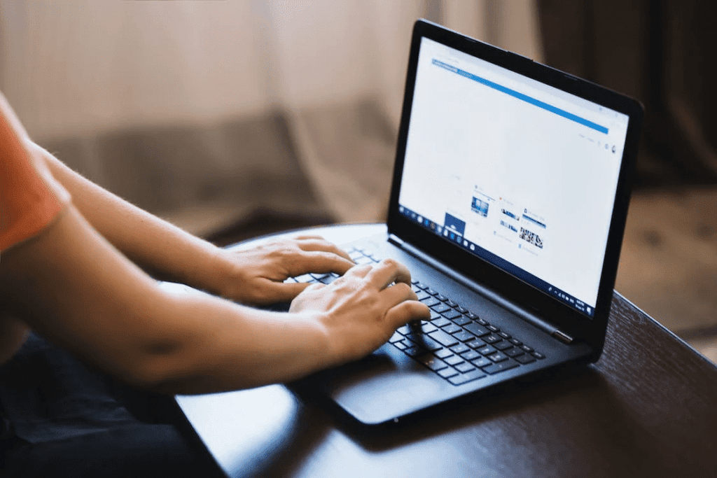 Check Out the WordPress Latest Version 2023 With New Features 2 A person typing on a laptop computer while using the latest version of WordPress.